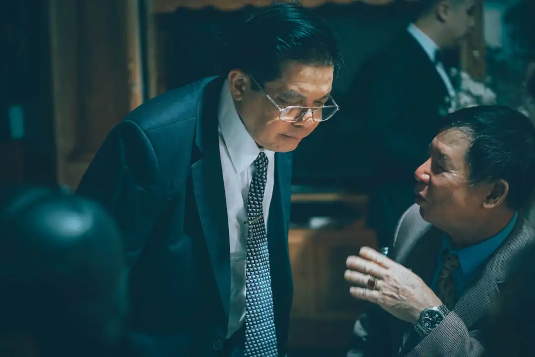 Two businessmen in suits talking intently