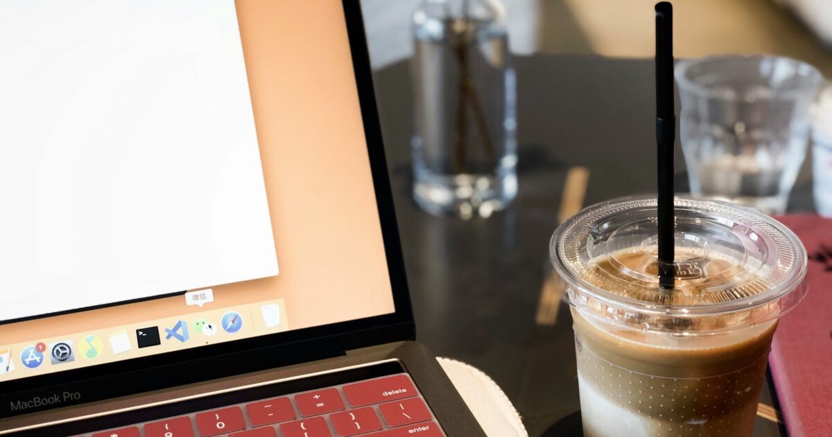 Laptop with coffee showing a blogging platform interface for content creation